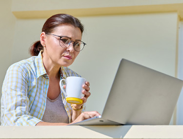 Woman on computer on porch