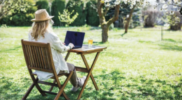 Woman outside on her laptop