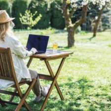 Woman outside on her laptop